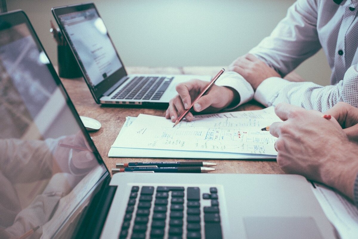 Two SIGMA consultants reviewing risk documentation